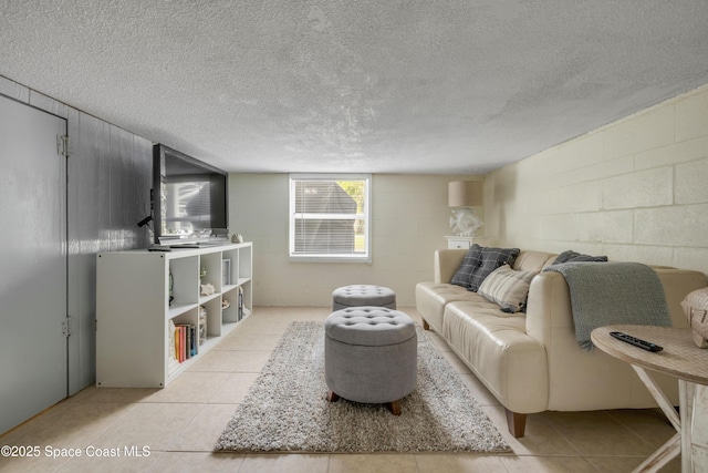 2007 Oak St, Melbourne Beach, FL 32951 - living room with concrete block wall, a textured ceiling, and light tile patterned floors
