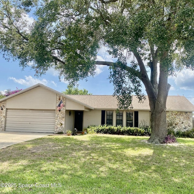 6855 Bryant Rd, Cocoa, FL 32927 - view of front facade with stone siding, an attached garage, a front lawn, concrete driveway, and roof with shingles