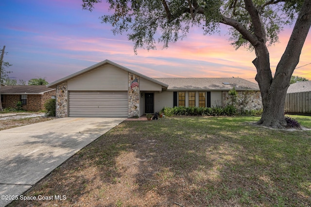 6855 Bryant Rd, Cocoa, FL 32927 - view of front of home featuring a garage, driveway, and a yard