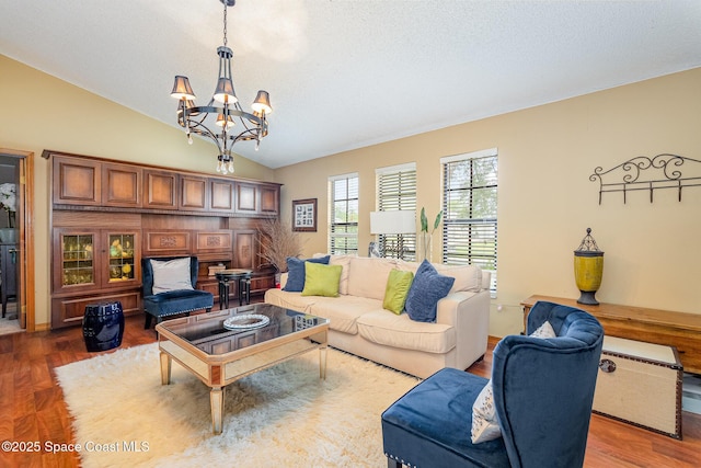 6855 Bryant Rd, Cocoa, FL 32927 - living room featuring a chandelier, vaulted ceiling, and wood finished floors