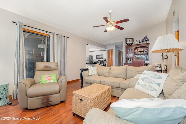 6855 Bryant Rd, Cocoa, FL 32927 - living area featuring a ceiling fan, wood finished floors, and vaulted ceiling