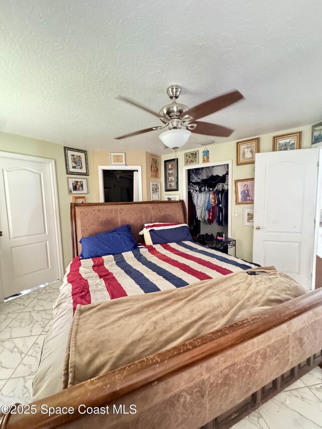 1112 Pine Creek Cir NE, Palm Bay, FL 32905 - bedroom with marble finish floors, a closet, a ceiling fan, and a textured ceiling