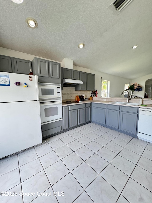 1112 Pine Creek Cir NE, Palm Bay, FL 32905 - kitchen with white appliances, gray cabinets, a sink, light countertops, and a textured ceiling