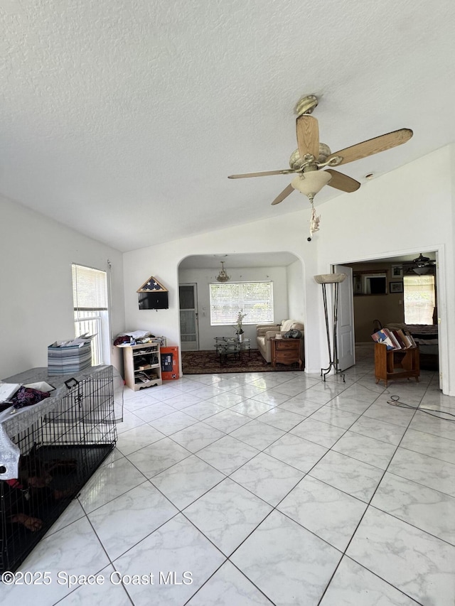 1112 Pine Creek Cir NE, Palm Bay, FL 32905 - living area featuring arched walkways, ceiling fan, and a textured ceiling