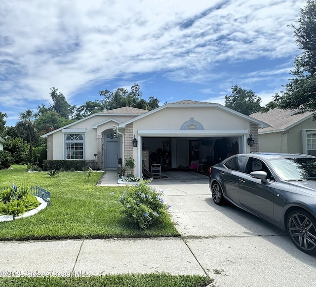 1112 Pine Creek Cir NE, Palm Bay, FL 32905 - single story home featuring a garage, concrete driveway, a front yard, brick siding, and stucco siding