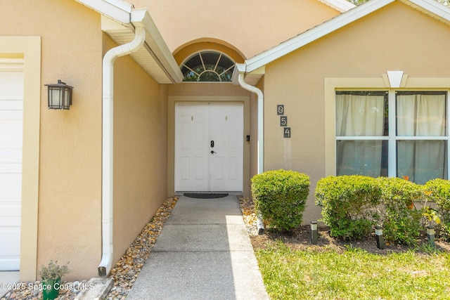 854 Belhurst Ln, Rockledge, FL 32955 - doorway to property featuring stucco siding