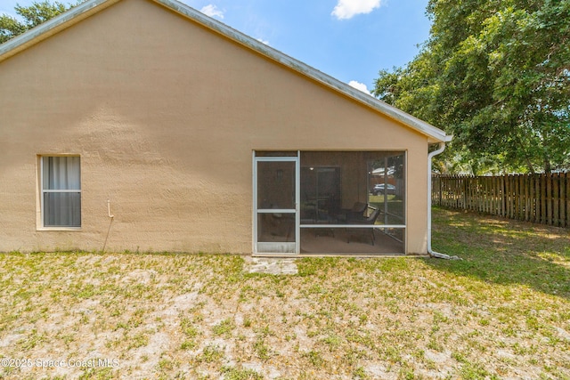 854 Belhurst Ln, Rockledge, FL 32955 - rear view of property featuring a sunroom and stucco siding
