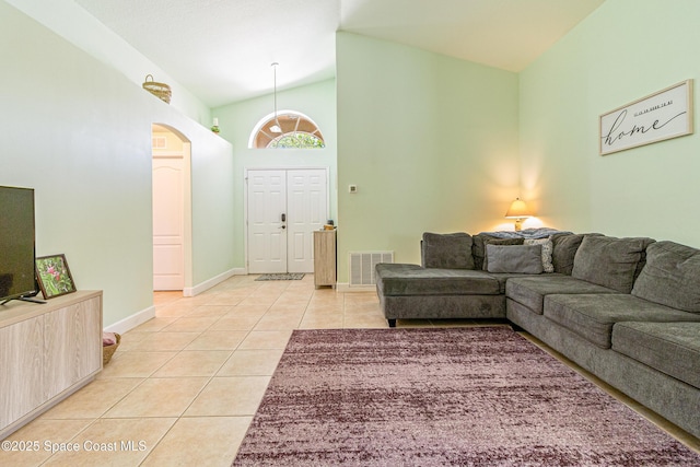 854 Belhurst Ln, Rockledge, FL 32955 - living room with light tile patterned floors, lofted ceiling, baseboards, and arched walkways