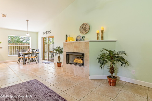 854 Belhurst Ln, Rockledge, FL 32955 - tiled living area featuring a tile fireplace, baseboards, and high vaulted ceiling