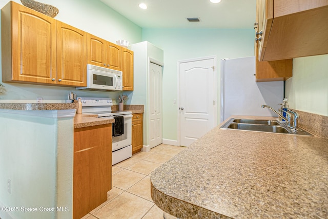 854 Belhurst Ln, Rockledge, FL 32955 - kitchen with white appliances, a sink, light tile patterned flooring, and recessed lighting