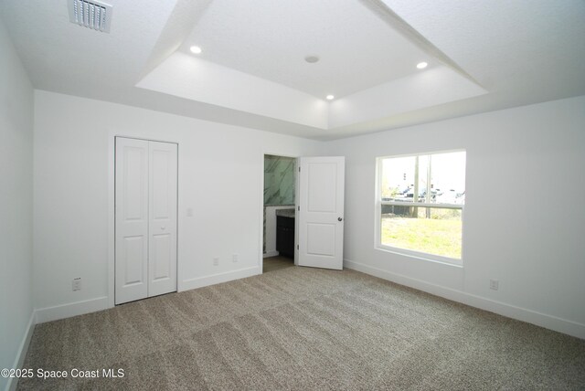 1558 Pentax Ave, Titusville, FL 32796 - unfurnished bedroom with a raised ceiling, carpet, baseboards, and recessed lighting