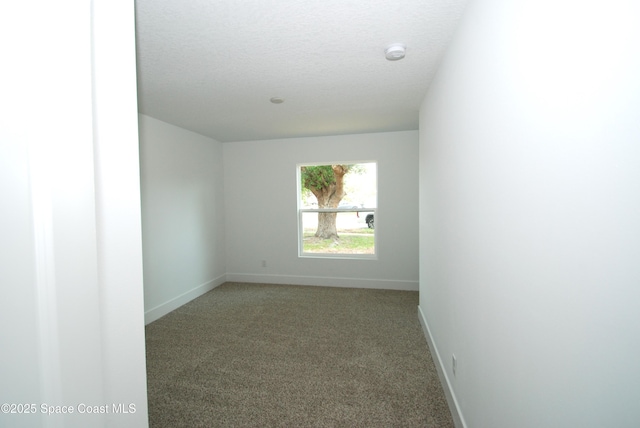 1558 Pentax Ave, Titusville, FL 32796 - carpeted spare room with a smoke detector, baseboards, and a textured ceiling