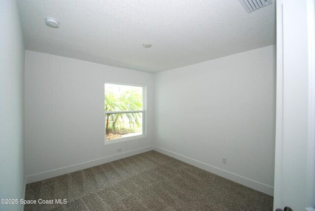 1558 Pentax Ave, Titusville, FL 32796 - spare room featuring baseboards, carpet, a smoke detector, and a textured ceiling