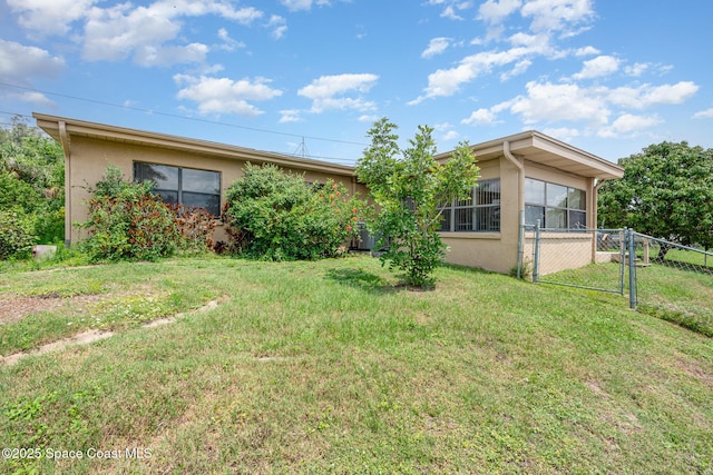 6519 June Dr, Cocoa, FL 32926 - back of property featuring stucco siding and a sunroom