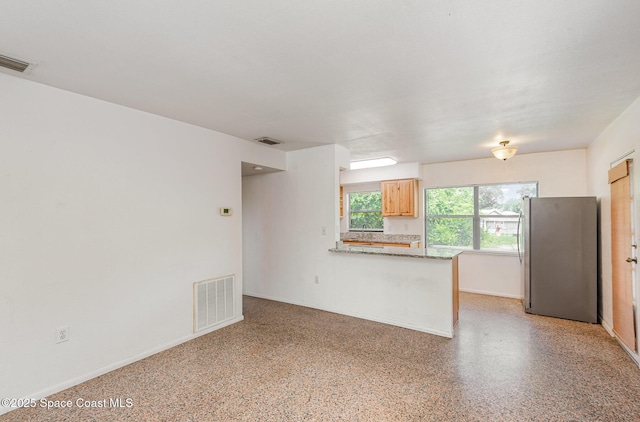 6519 June Dr, Cocoa, FL 32926 - unfurnished living room with dark speckled floor and baseboards