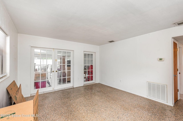 6519 June Dr, Cocoa, FL 32926 - empty room featuring french doors and speckled floor