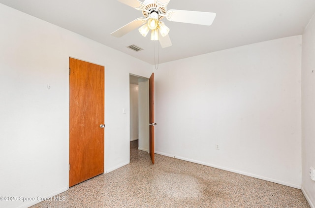 6519 June Dr, Cocoa, FL 32926 - unfurnished room with dark speckled floor, a ceiling fan, and baseboards