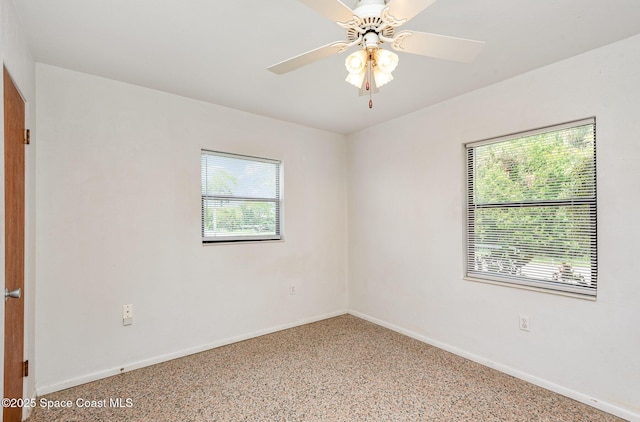 6519 June Dr, Cocoa, FL 32926 - spare room featuring plenty of natural light, baseboards, and ceiling fan