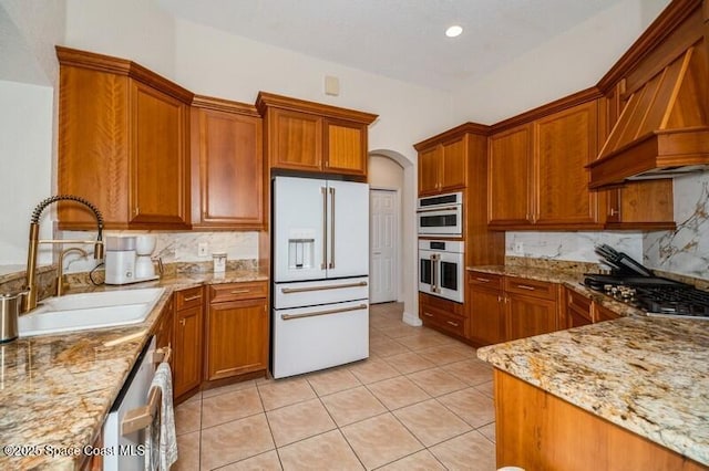 4178 Ventana Blvd, Rockledge, FL 32955 - kitchen with stainless steel appliances, a sink, custom exhaust hood, tasteful backsplash, and light stone countertops