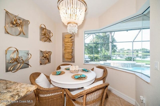4178 Ventana Blvd, Rockledge, FL 32955 - dining space featuring a sunroom, light tile patterned floors, baseboards, and a chandelier