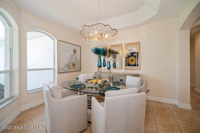 4178 Ventana Blvd, Rockledge, FL 32955 - dining room with light tile patterned floors, a chandelier, baseboards, and arched walkways