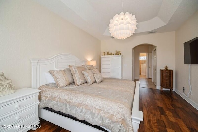 4178 Ventana Blvd, Rockledge, FL 32955 - bedroom with arched walkways, wood finished floors, and a chandelier