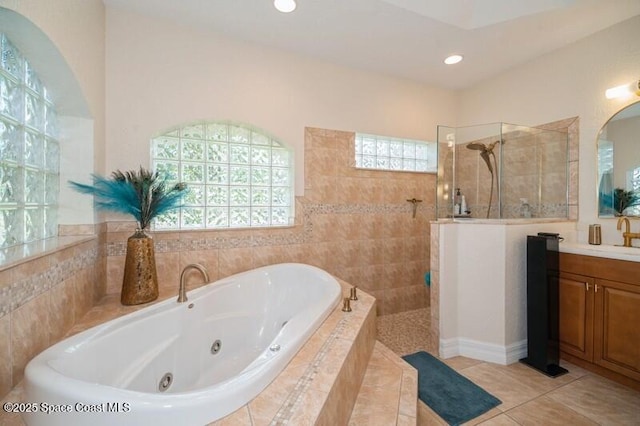 4178 Ventana Blvd, Rockledge, FL 32955 - bathroom featuring a jetted tub, a walk in shower, vanity, recessed lighting, and tile patterned flooring