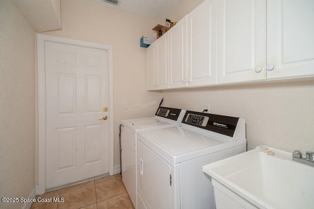 4178 Ventana Blvd, Rockledge, FL 32955 - laundry room with separate washer and dryer, cabinet space, light tile patterned flooring, and baseboards