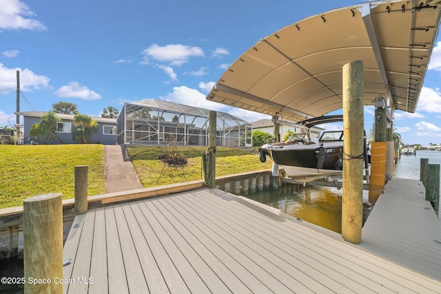 dock featuring a water view, boat lift, a yard, and a lanai