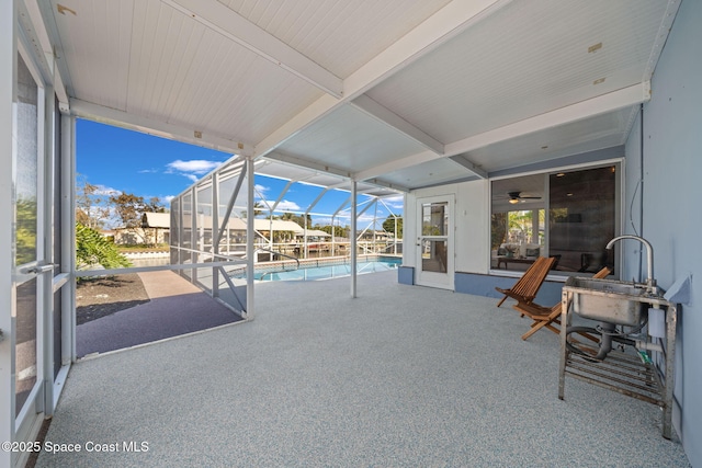 view of patio featuring an outdoor pool and glass enclosure