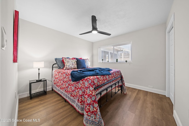 bedroom featuring wood finished floors, baseboards, and ceiling fan