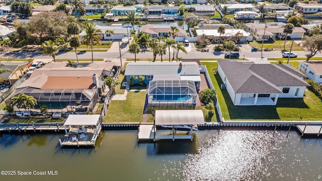 aerial view of residential area featuring a large body of water