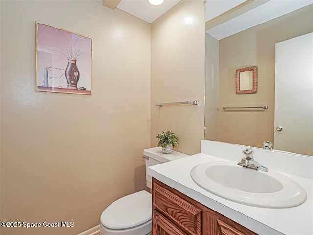 half bathroom with toilet and vanity