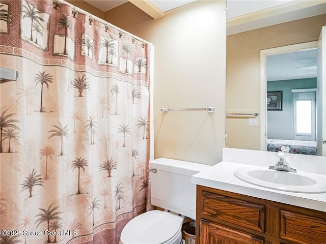 full bathroom featuring vanity, toilet, and ensuite bathroom
