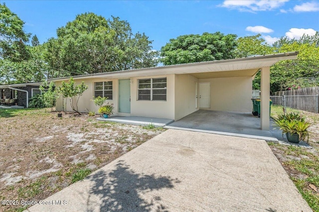133 Lee Rd, Melbourne, FL 32904 - single story home with concrete driveway, stucco siding, and an attached carport
