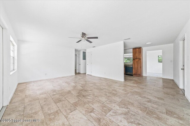 133 Lee Rd, Melbourne, FL 32904 - unfurnished living room featuring ceiling fan and baseboards