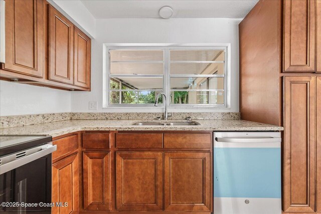 133 Lee Rd, Melbourne, FL 32904 - kitchen with dishwashing machine, a sink, stainless steel range with electric stovetop, brown cabinetry, and light stone counters