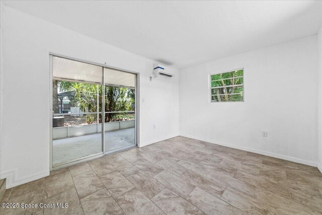 133 Lee Rd, Melbourne, FL 32904 - unfurnished room with a wall mounted AC and baseboards