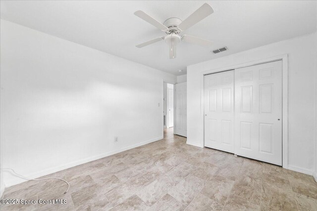 133 Lee Rd, Melbourne, FL 32904 - unfurnished bedroom featuring baseboards, a closet, and a ceiling fan