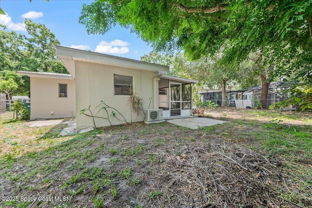 133 Lee Rd, Melbourne, FL 32904 - rear view of property featuring a sunroom, a cooling unit, and stucco siding