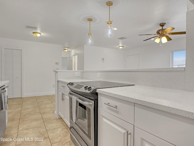kitchen with stainless steel electric range, light tile patterned floors, pendant lighting, white cabinetry, and ceiling fan