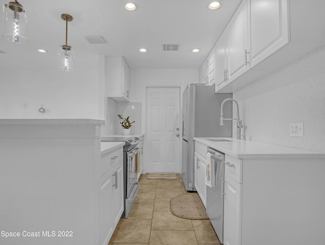 kitchen featuring stainless steel appliances, a sink, recessed lighting, white cabinetry, and light countertops