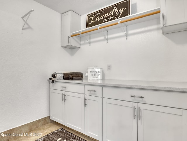 washroom with baseboards