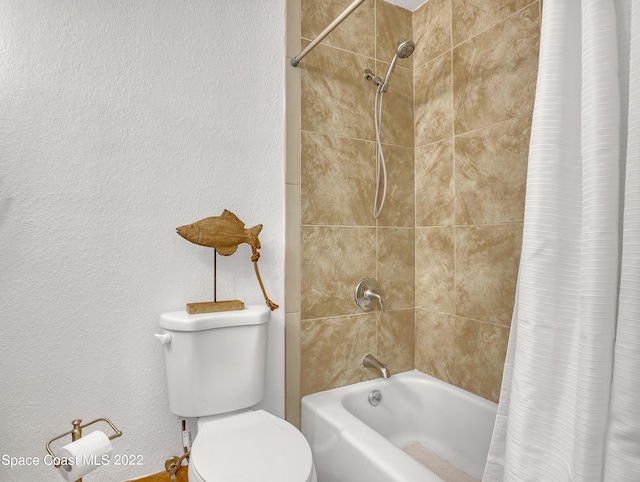 full bath featuring shower / bath combo, toilet, and a textured wall