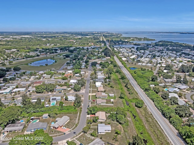 view of property location with a large body of water and nearby suburban area