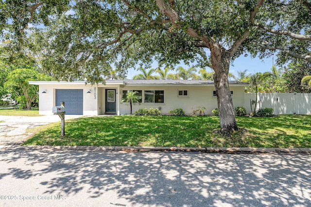 8103 Magnolia Ave, Cape Canaveral, FL 32920 - single story home featuring a garage, stucco siding, and concrete driveway