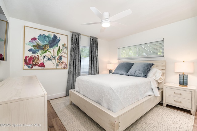8103 Magnolia Ave, Cape Canaveral, FL 32920 - bedroom featuring wood finished floors, a ceiling fan, and baseboards