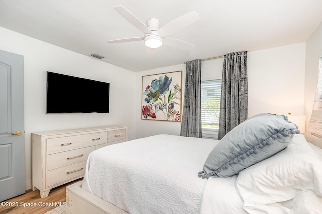 8103 Magnolia Ave, Cape Canaveral, FL 32920 - bedroom with light wood finished floors and ceiling fan