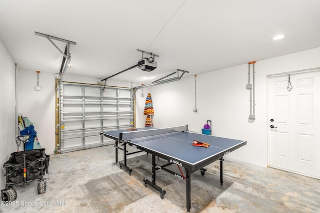 8103 Magnolia Ave, Cape Canaveral, FL 32920 - playroom featuring a garage, unfinished concrete floors, and recessed lighting