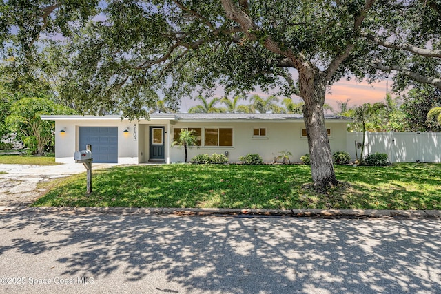 8103 Magnolia Ave, Cape Canaveral, FL 32920 - ranch-style home featuring an attached garage, driveway, and stucco siding